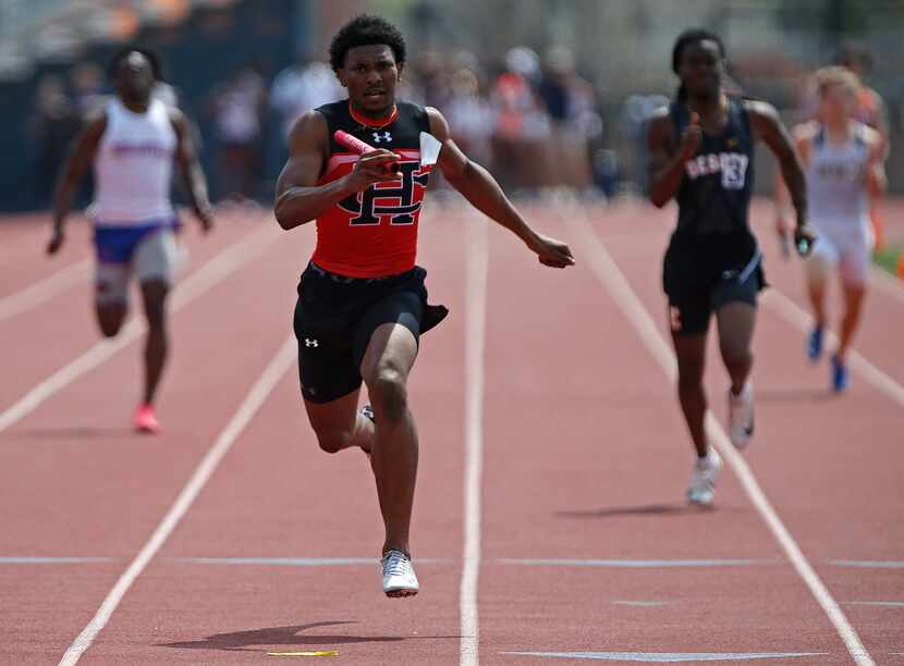 Diallo Good, 18, finishes first in the boys 4x100 for Cedar Hill High School during the...