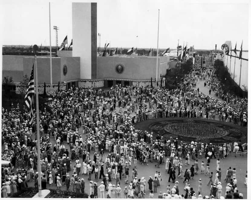 Visitors crowd the plaza in front of the Federal Building at Fair Park during the Texas...