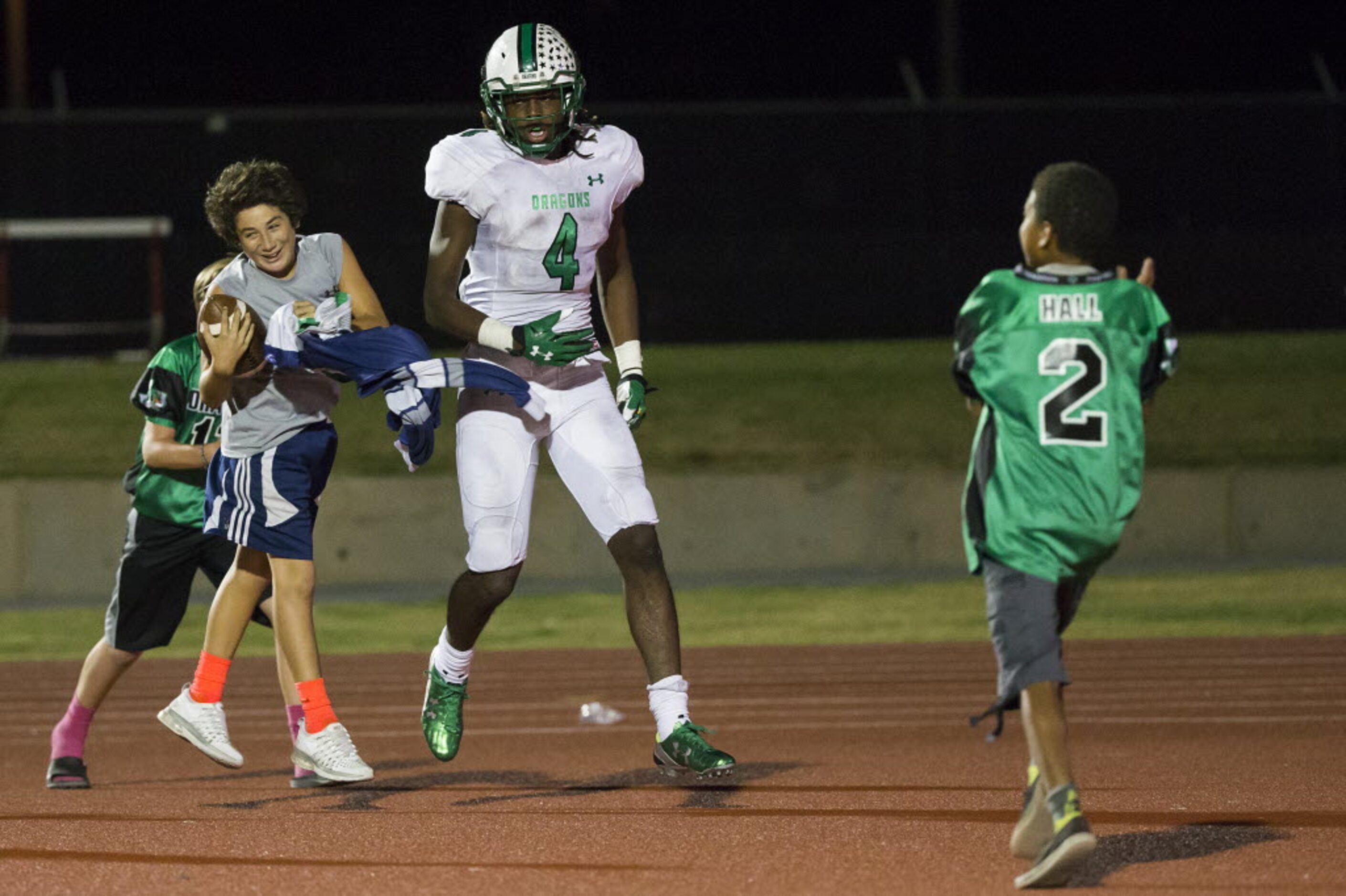 Ballboys rush to celebrate with Southlake Carroll's Lil' Jordan Humphrey (4) after he scored...