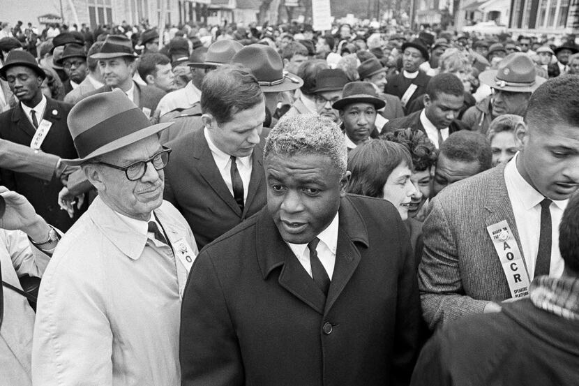  In this March 5, 1964 file photo,  Jackie Robinson, center, appears with demonstrators in a...