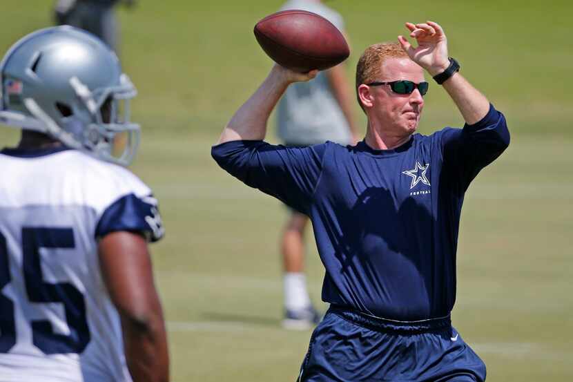 Dallas head coach Jason Garrett throws a pass during the Dallas Cowboys OTA practice at...