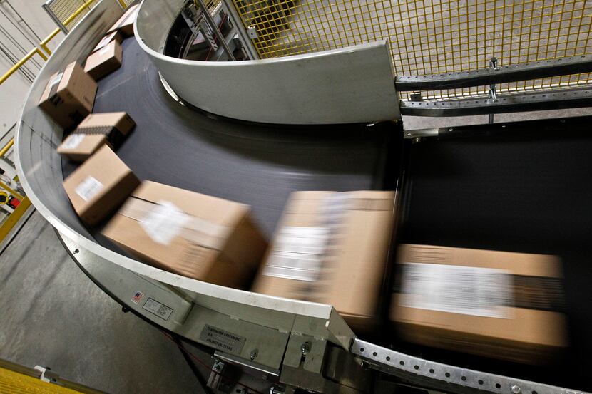 Packages ready to ship move along a conveyor belt at Amazon.com's Phoenix fulfillment...
