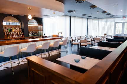 Maiden, a vegan tasting menu restaurant, is a moody room with a wall of windows and accents...