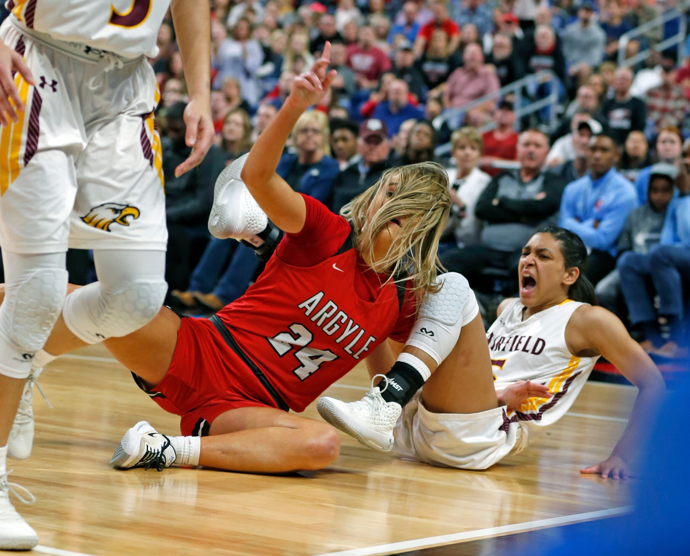 Argyle guard Abby Williams #24 fights for a loose ball with Fairfield guard Kaylee Adams #5...