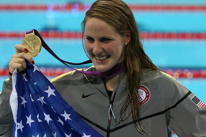 Gold Medalist Missy Franklin poses for photos after winning the women's 100m backstroke...