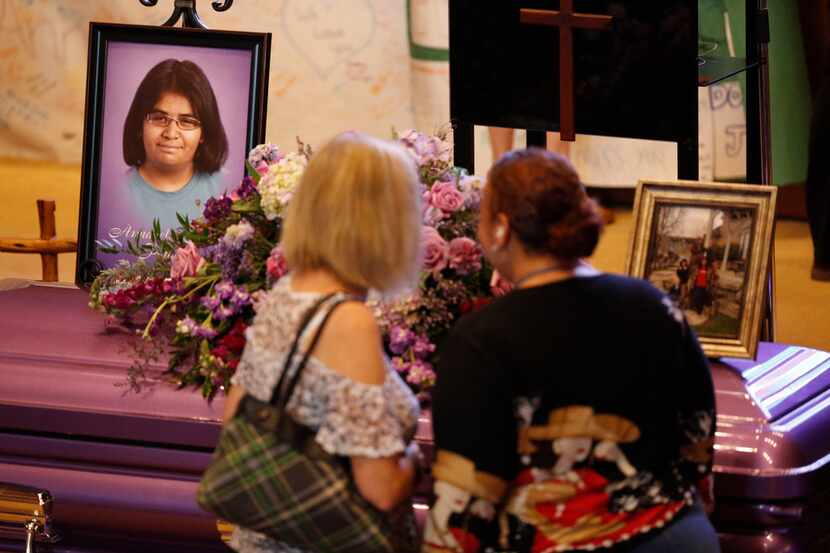 People pay their respects before the funeral service for Annabelle Pomeroy, one of those...