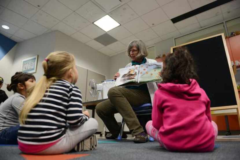 Coppell Librarian Betsy Merrill reads to children during family story time in this file...