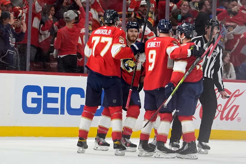 Florida Panthers center Sam Bennett (9) is congratulated after scoring during the first...
