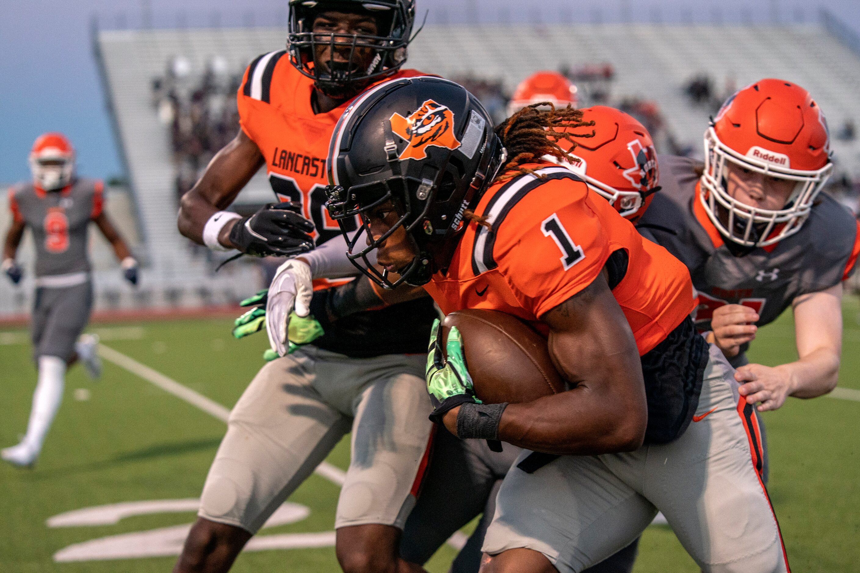 Lancaster senior running back Kyson Brown (1) powers past McKinney North junior safety Sean...