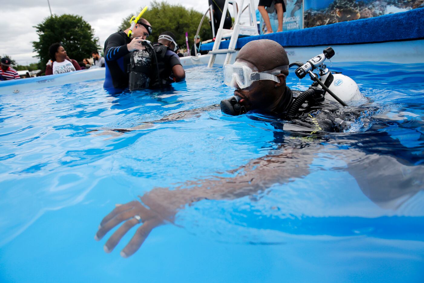 Jimmy Bradfield scuba dives in the Go Dive Now pool at Earth Day Texas in Fair Park in...