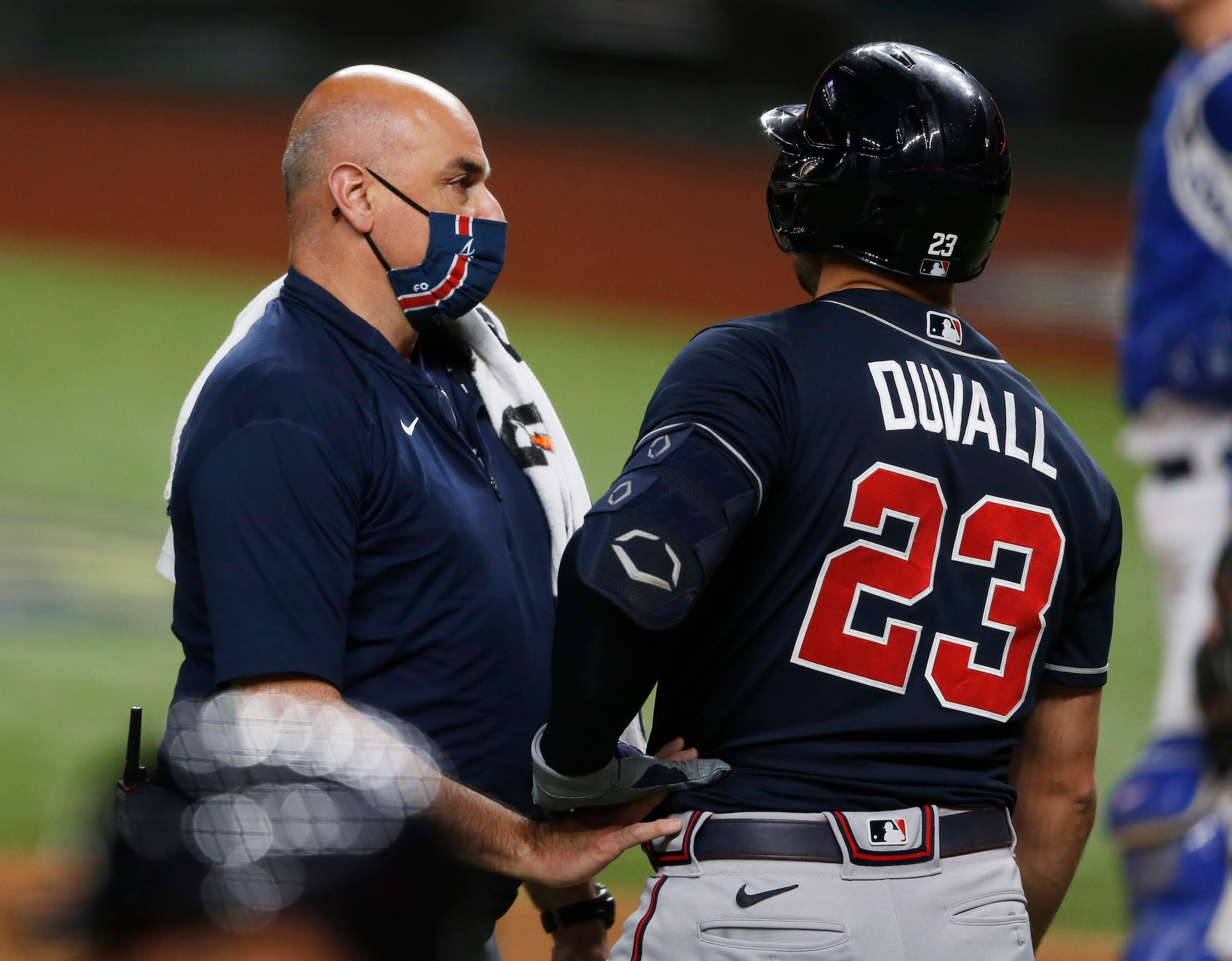 Atlanta Braves official tends to Atlanta Braves left fielder Adam Duvall (23) after an...