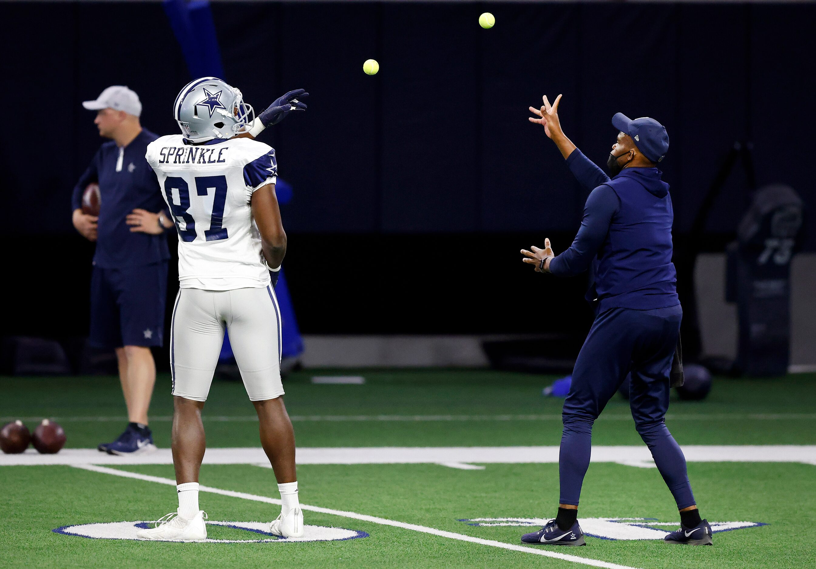 Dallas Cowboys tight end Jeremy Sprinkle (87) and tight ends coach Lunda Wells play catch...