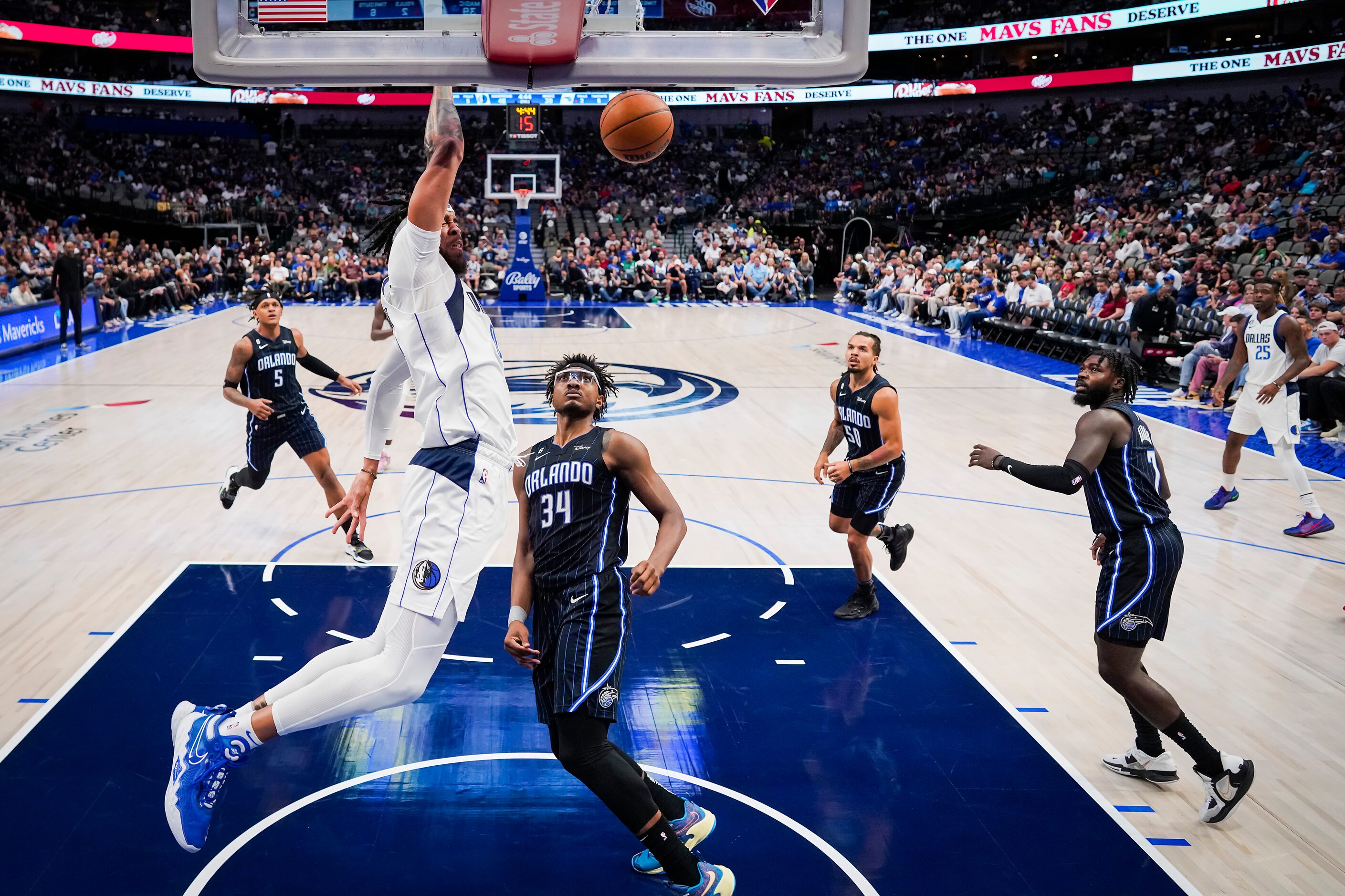 Dallas Mavericks center JaVale McGee (00) dunks the ball past Orlando Magic center Wendell...