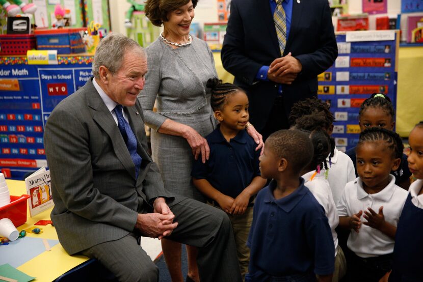 Former President George W. Bush and former first lady Laura Bush talk to students in Sharla...