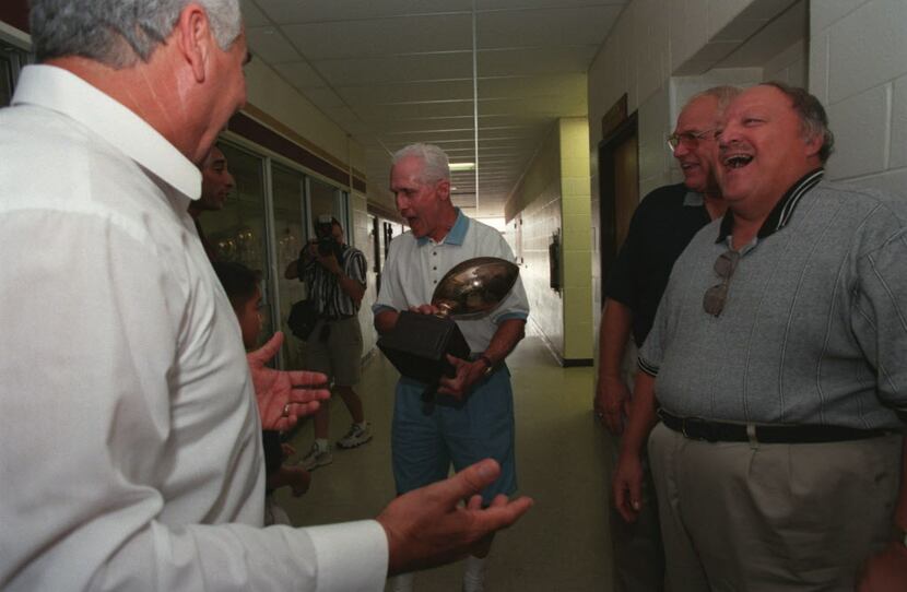 Coach Earl Scott holds the trophy that the 1961 Donna High School football team won at the...