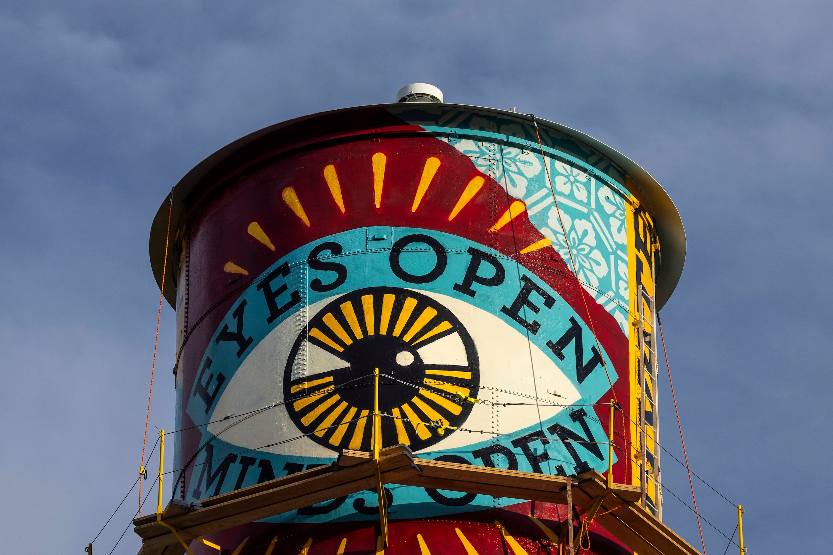 A new mural by Shepard Fairey appears on the side of a water tower by the Continental Gin...