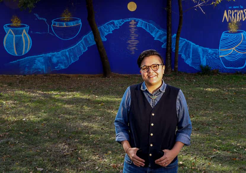 Angela Faz posed for a portrait in front of her mural in Dallas on Nov. 17, 2021. The piece...