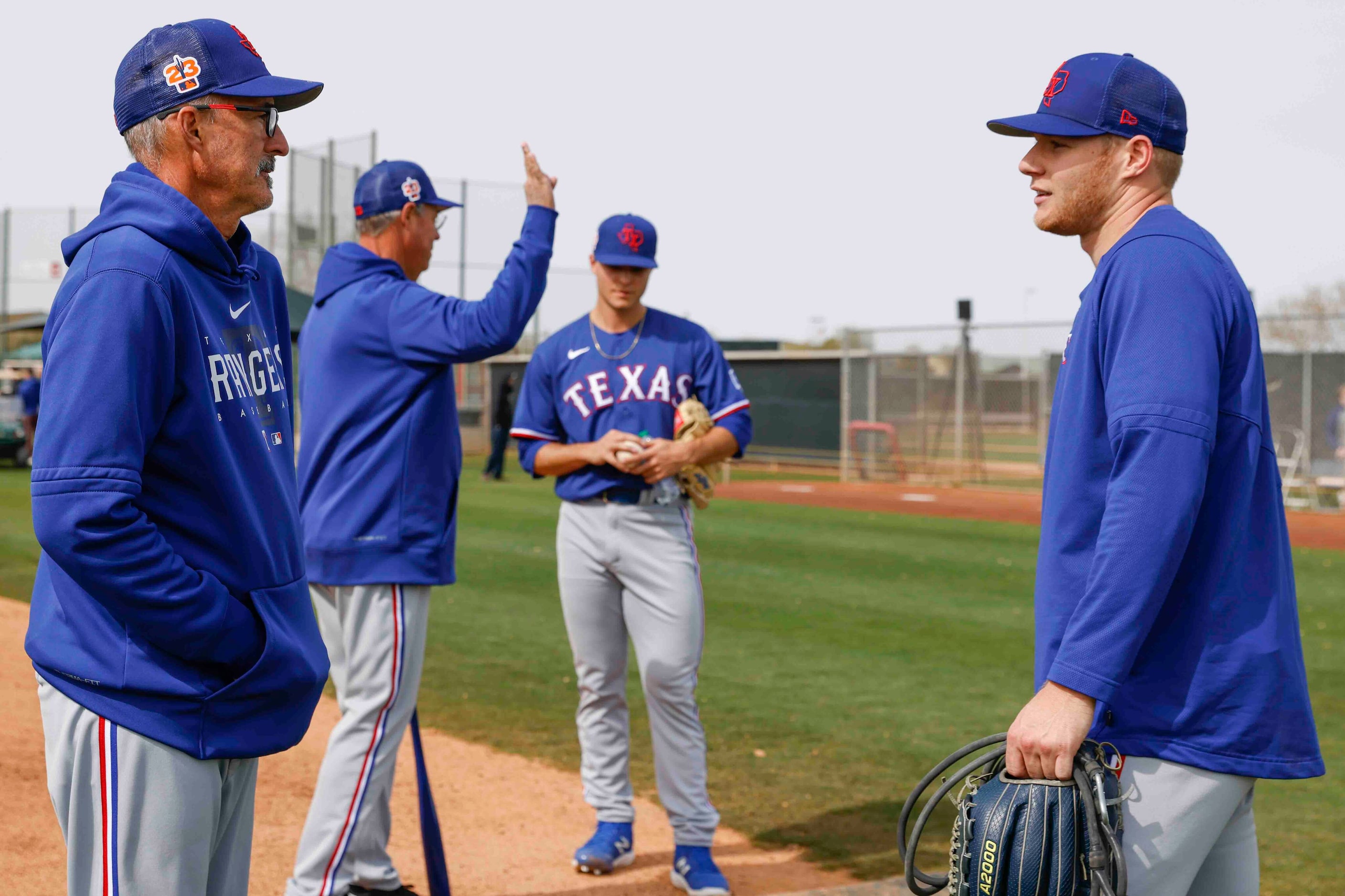 Texas Rangers pitching coach Mike Maddux, front left, and special assistant Greg Maddux,...