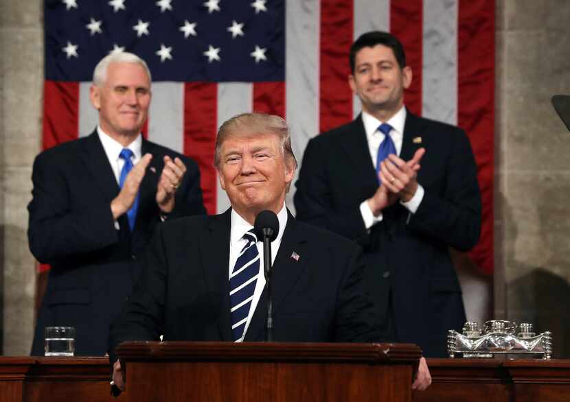 President Donald Trump, flanked by Vice President Mike Pence and House Speaker Paul Ryan of...