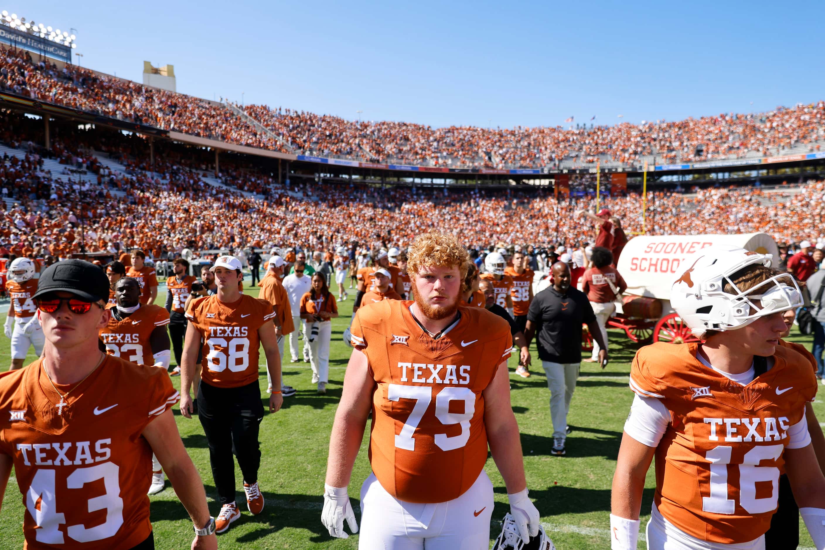 Texas players including Texas offensive lineman Connor Stroh (79) leave the field after...