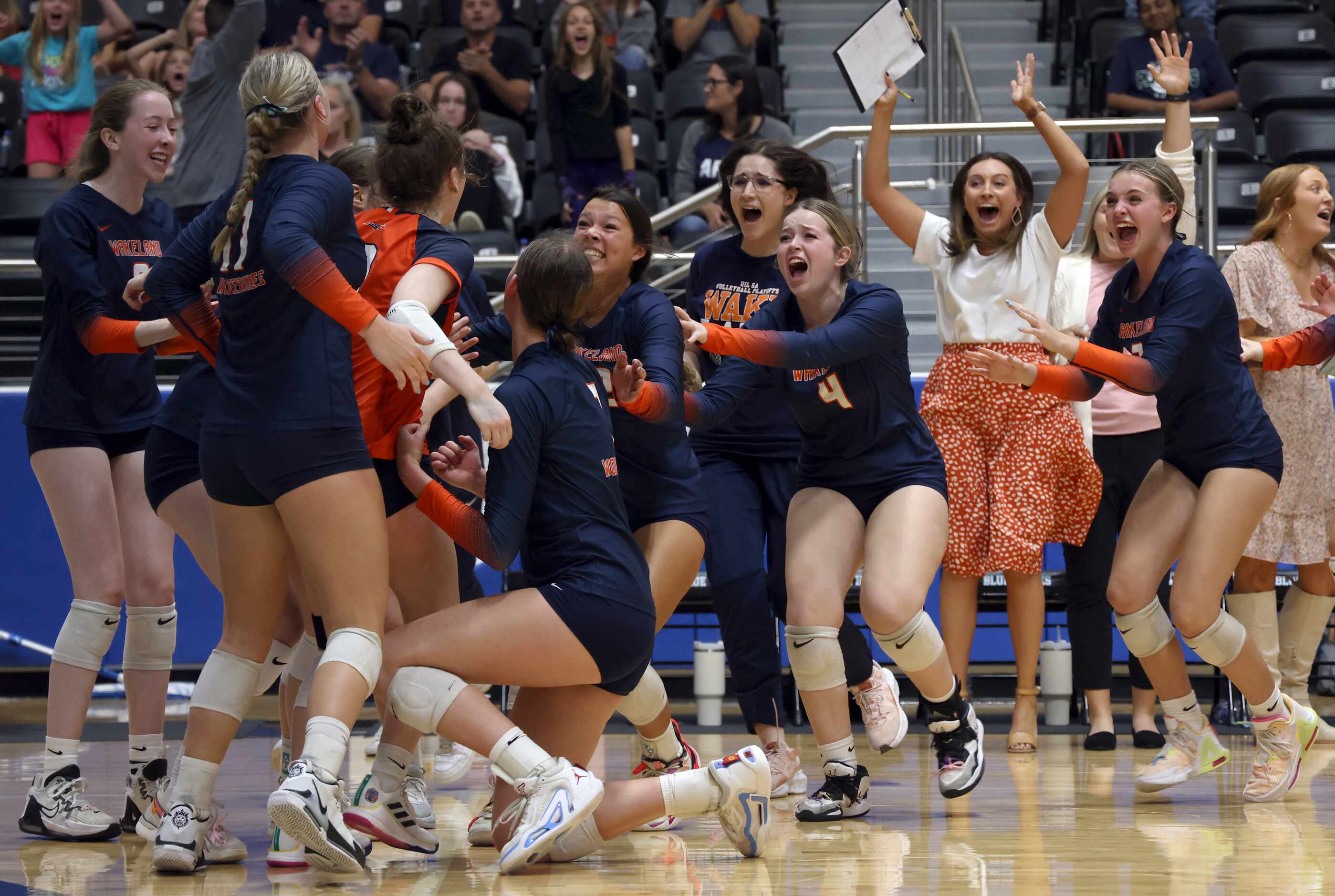 Frisco Wakeland players and coaches erupt from the team bench area to join the celebration...