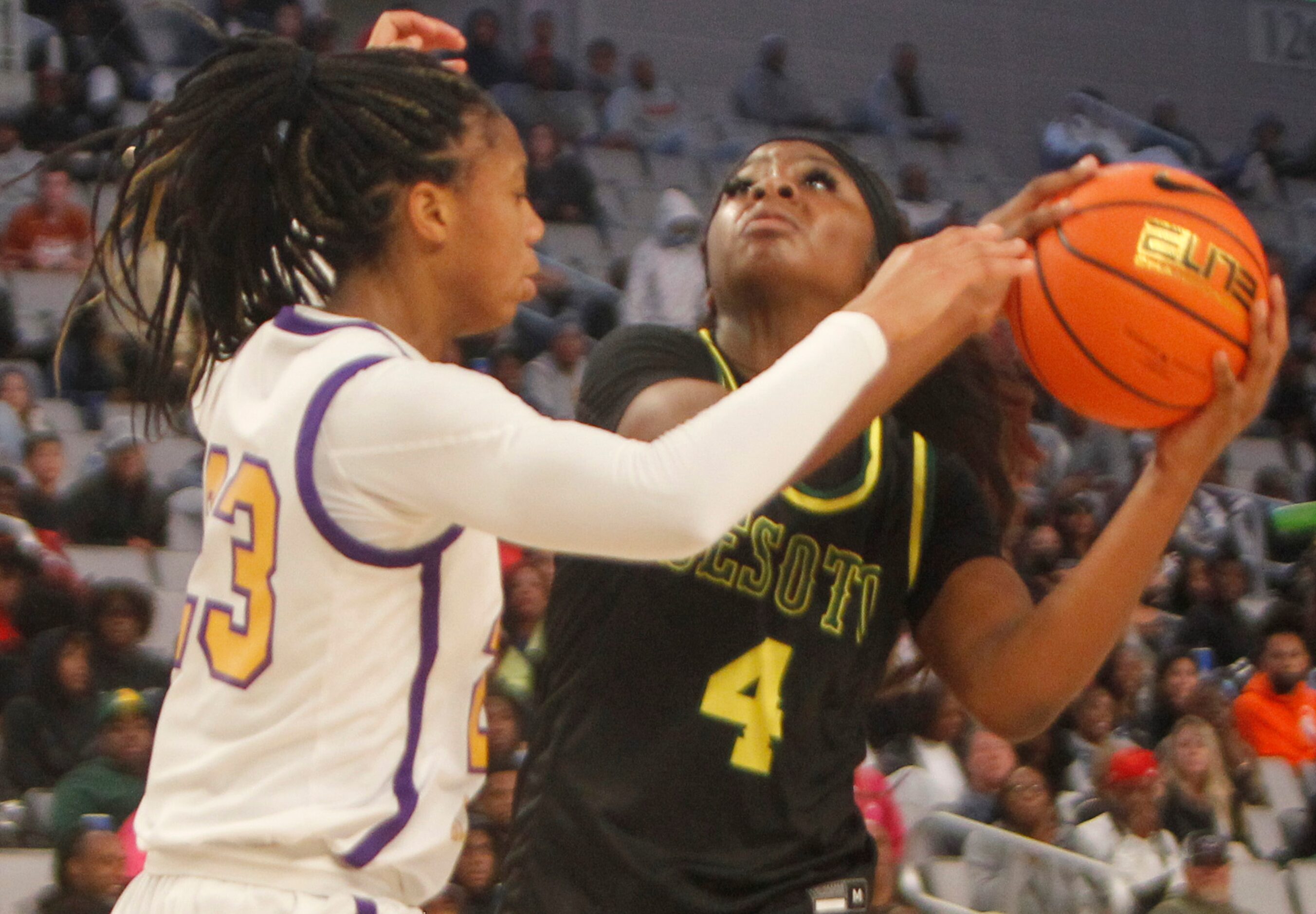 DeSoto senior Ja'Mia Harris (4), left, shoots against the defense of Montverde Academy guard...