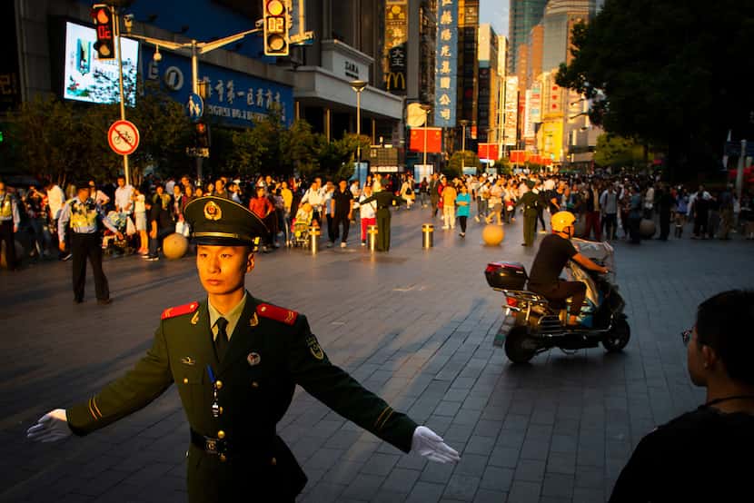 To keep the crowds out of traffic, soldiers were stationed every few meters on East Nanjing...