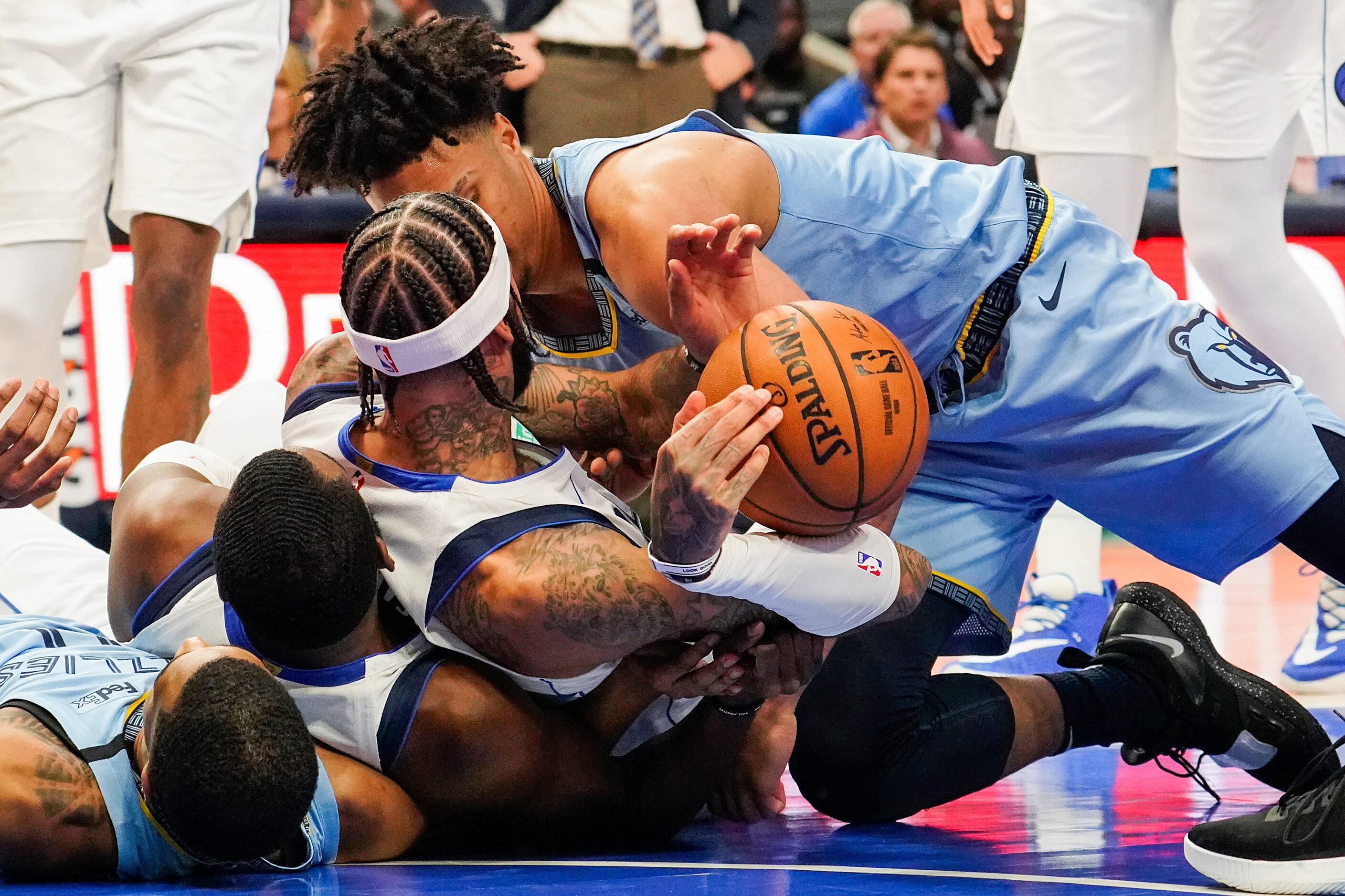 Dallas Mavericks center Willie Cauley-Stein (33) tumbles onto guard Tim Hardaway Jr. (11) as...