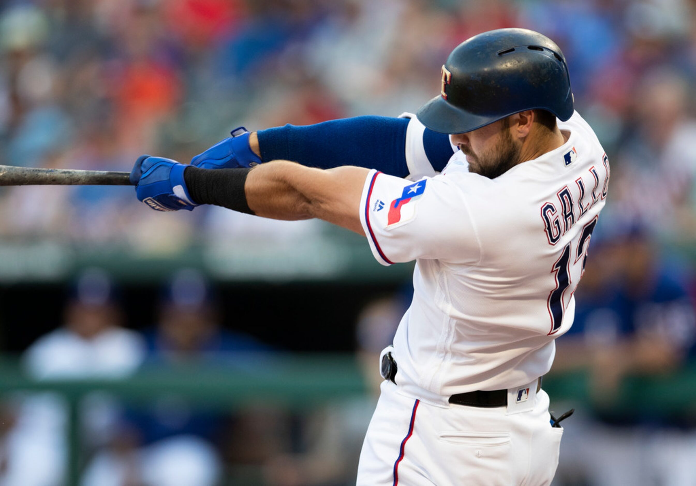 Texas Rangers' Joey Gallo follows through on a solo home run against the Oakland Athletics...