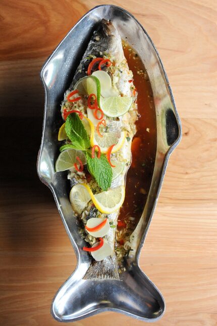 Kin Kin serves steamed branzino with garlic, Thai chili, cilantro, onion and lemon.