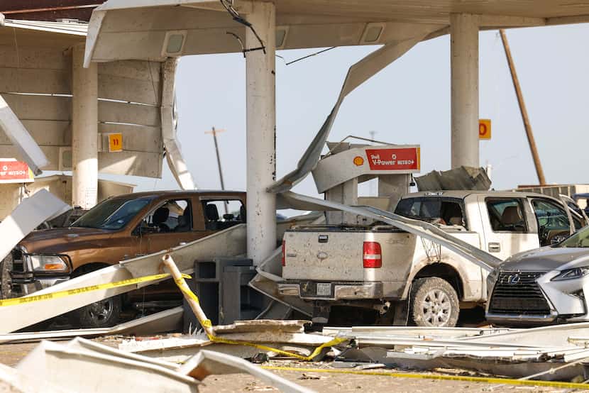 Damaged vehicles remain inside a Shell gas station, on Sunday, May 26, 2024, in Valley View,...
