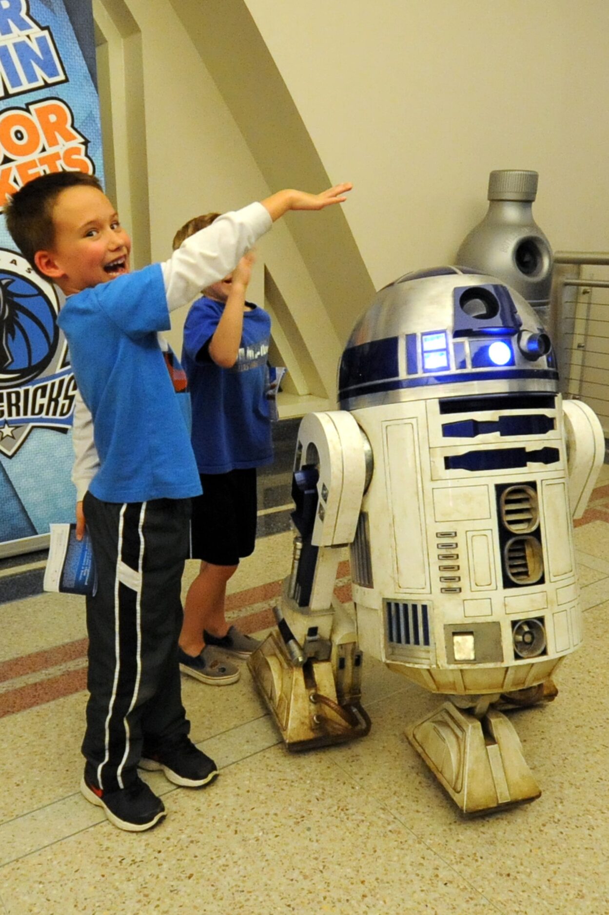 A Star Wars fan meets R2-D2 at Star Wars night at the Dallas Mavericks basketball game at...