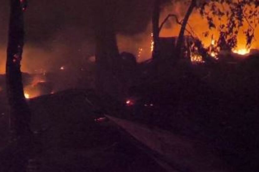 Union Pacific cars burn after a derailment caused ethanol to spill Wednesday morning in Fort...