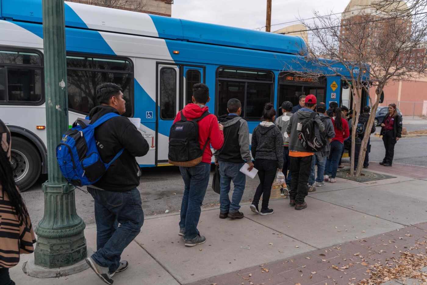 Central American migrants board El Paso Sun Metro busses after being dropped off in downtown...