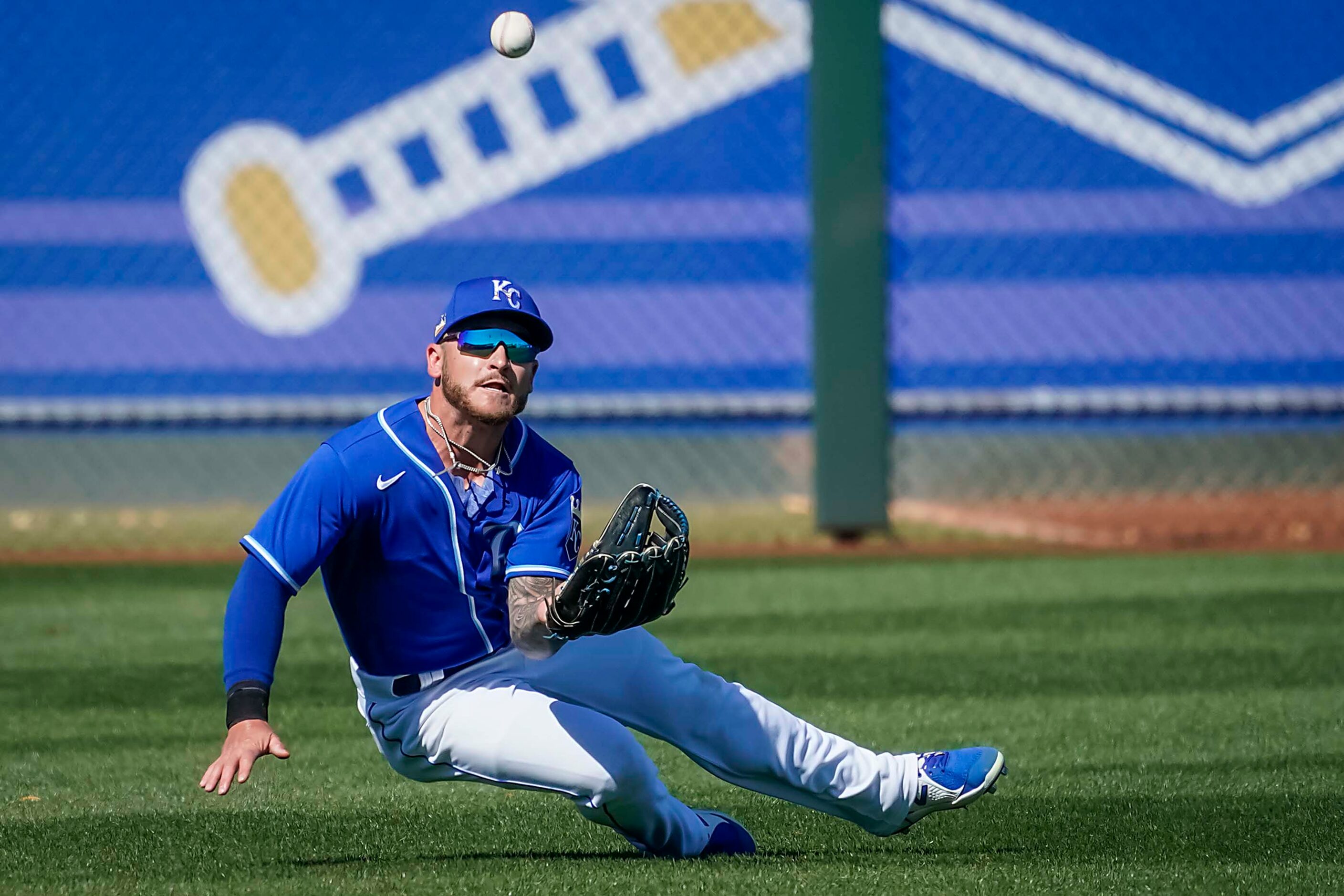 Kansas City Royals left fielder Kyle Isbel makes a sliding catch on a line drive off the bat...