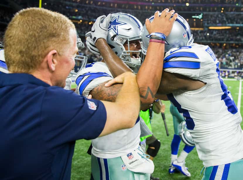 Dallas Cowboys head coach Jason Garrett celebrates with quarterback Dak Prescott (4) and...