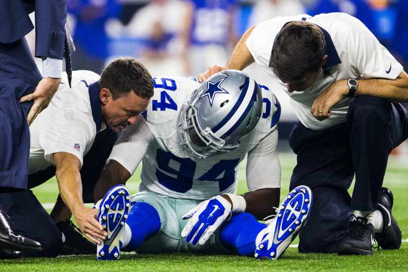 Dallas Cowboys defensive end Randy Gregory (94) is checked out by trainers after an injury...