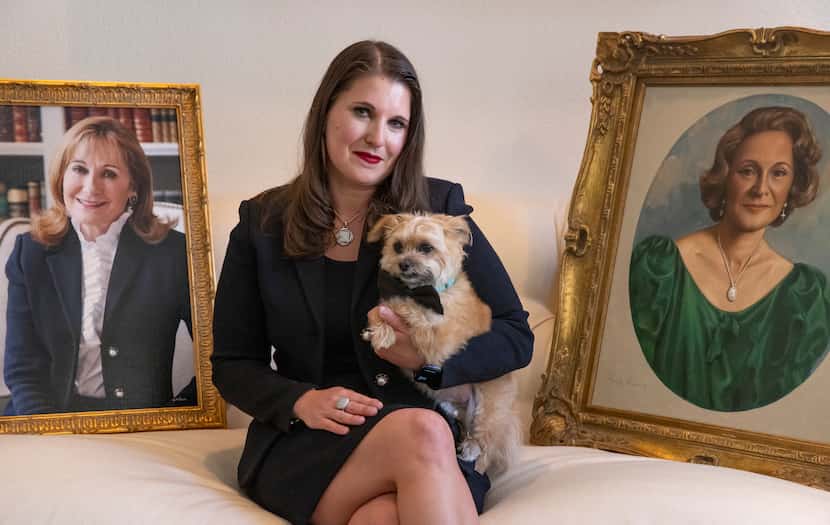 Courtney Underwood and her service dog, Brooks, pose for a portrait with a photograph of her...