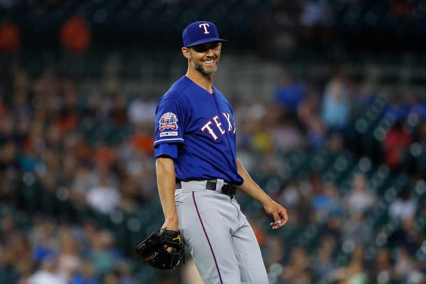 Texas Rangers pitcher Mike Minor smiles after the final out in the ninth inning of a...