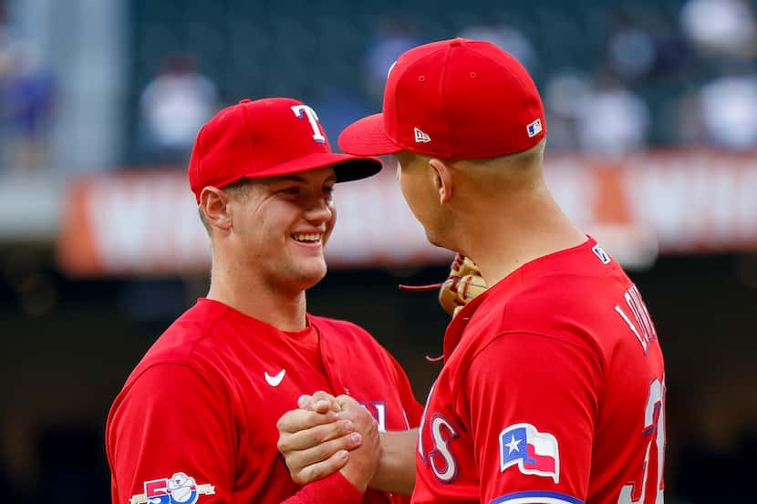 Texas Rangers third baseman Josh Jung (6) talks to Texas Rangers first baseman Nathaniel...