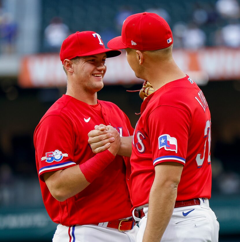 Texas Rangers third baseman Josh Jung (6) talks to Texas Rangers first baseman Nathaniel...