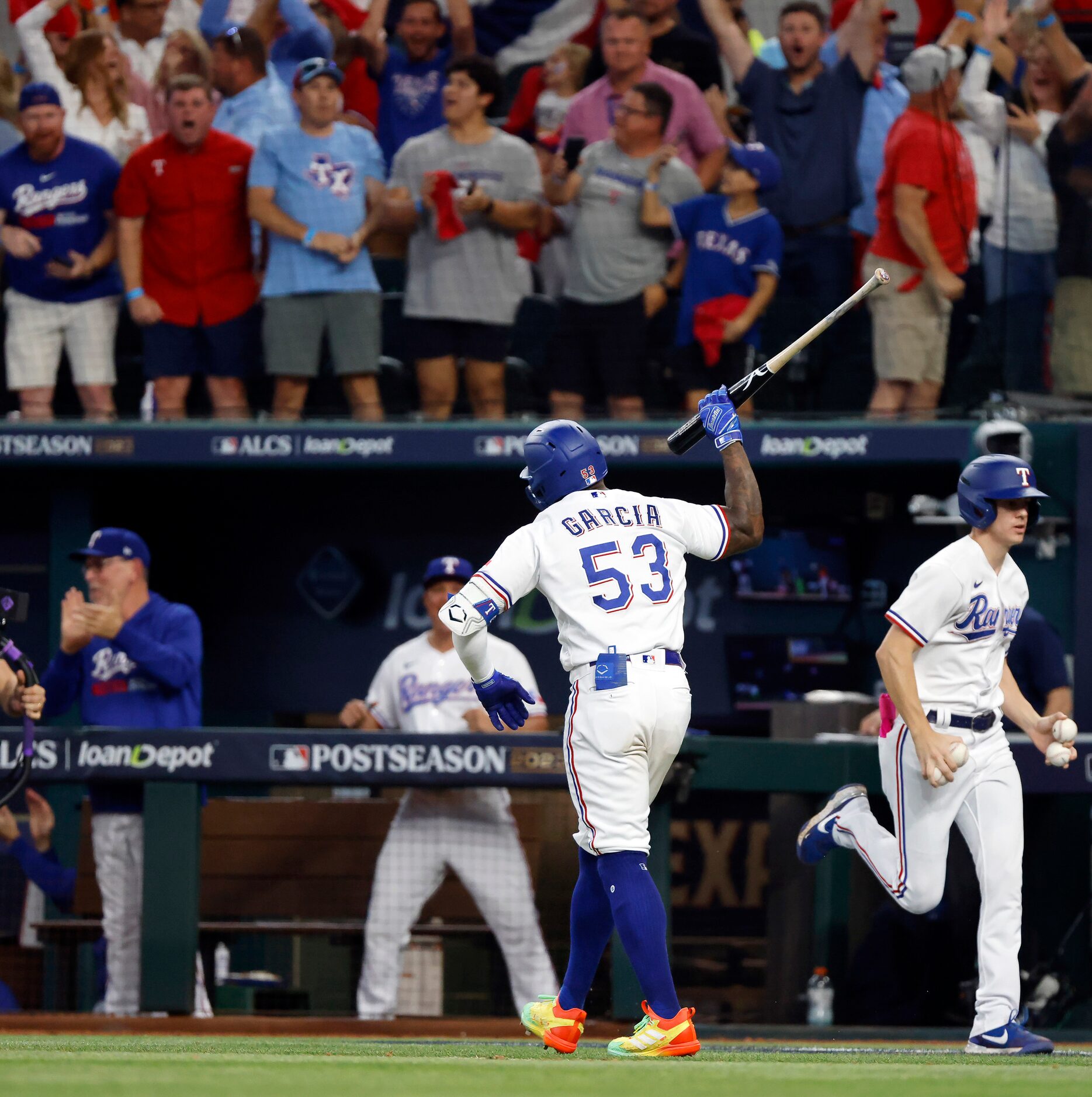 Texas Rangers batter Adolis Garcia (53) throws his bat after hitting a three-run homer off...