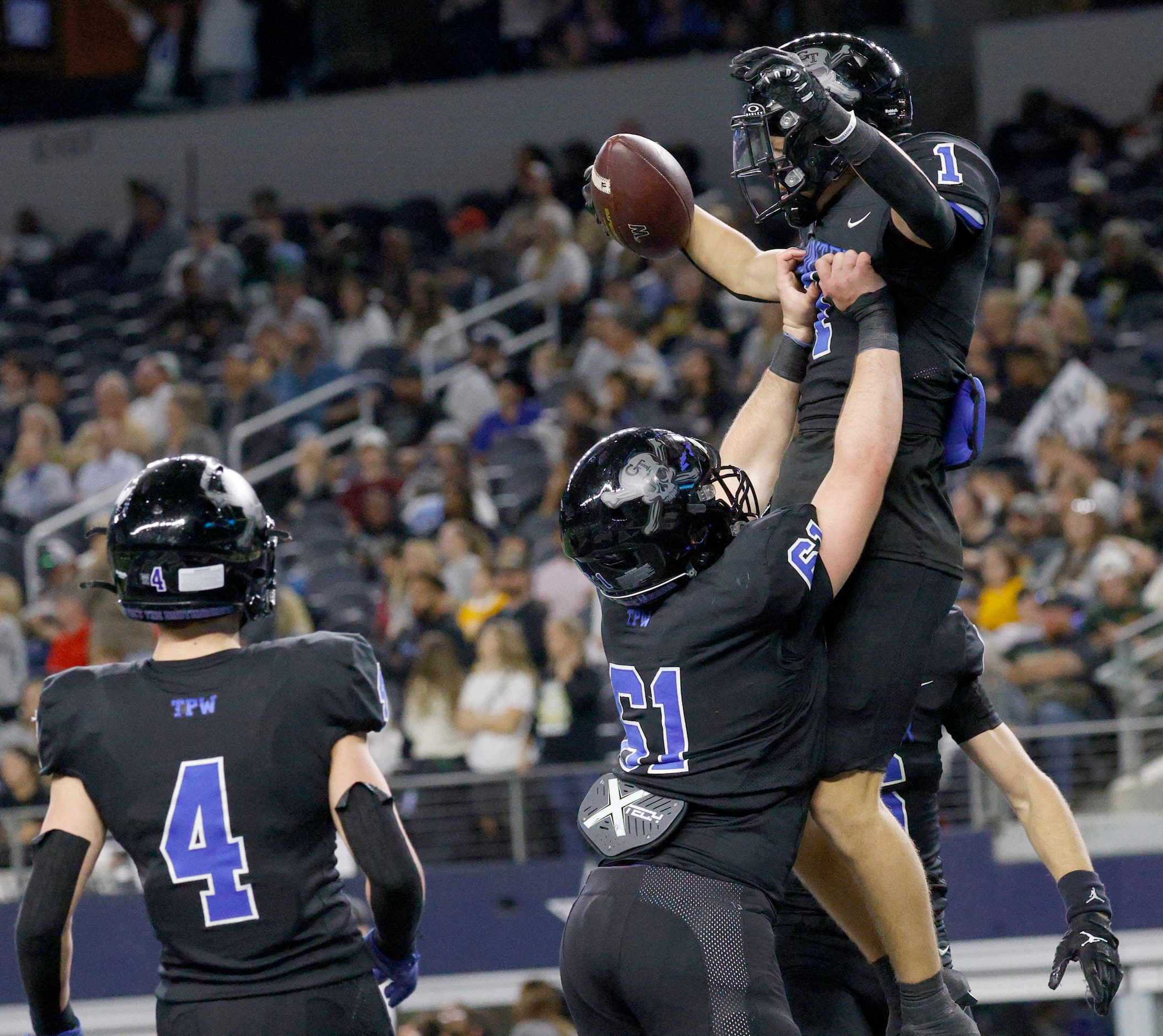 Gunter's Brock Boddie (1) celebrates with his teammates Garrin Goetz (61) and Braeden...