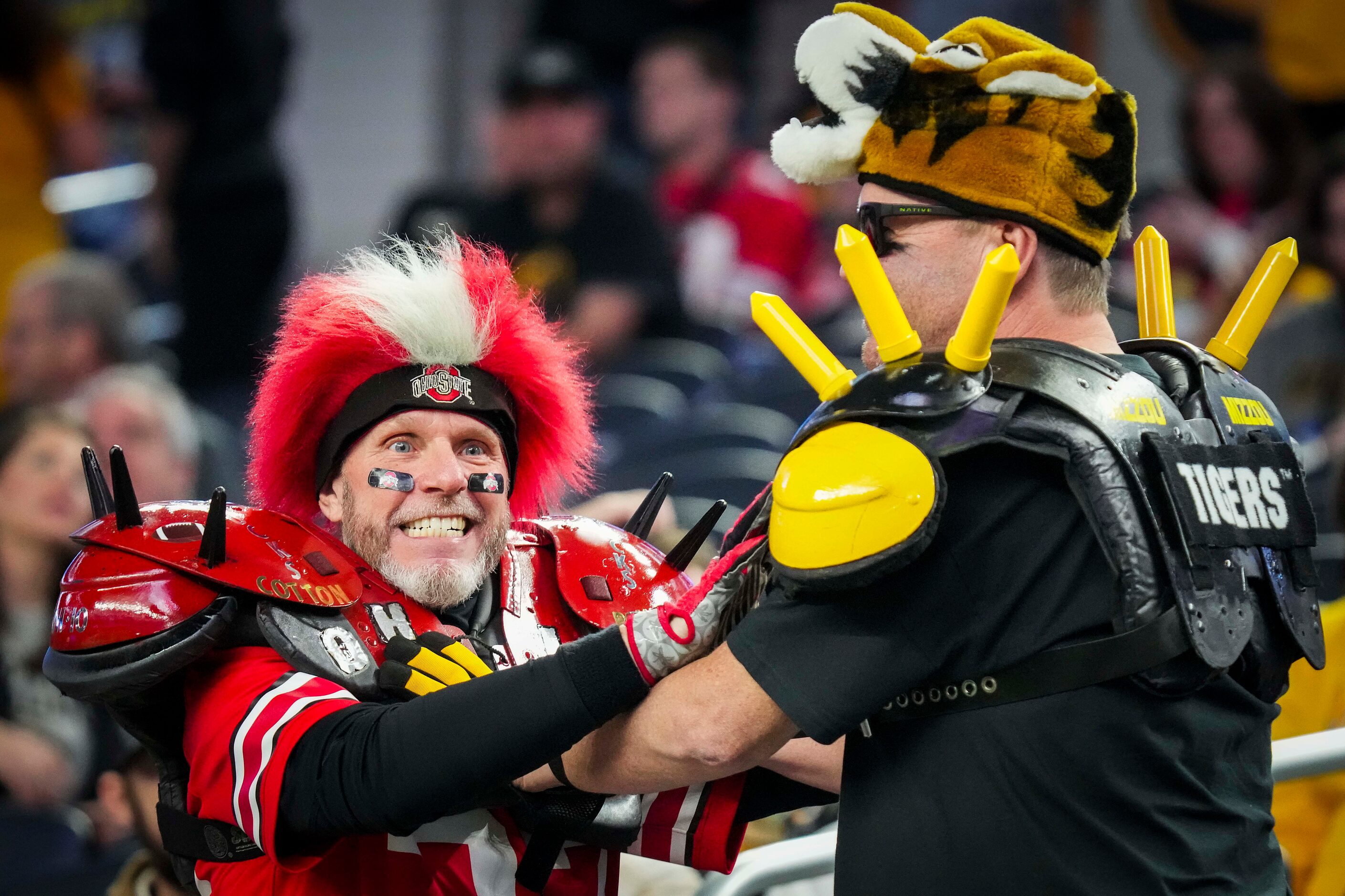 Ohio State and Missouri fans horse around before the Goodyear Cotton Bowl Classic on Friday,...