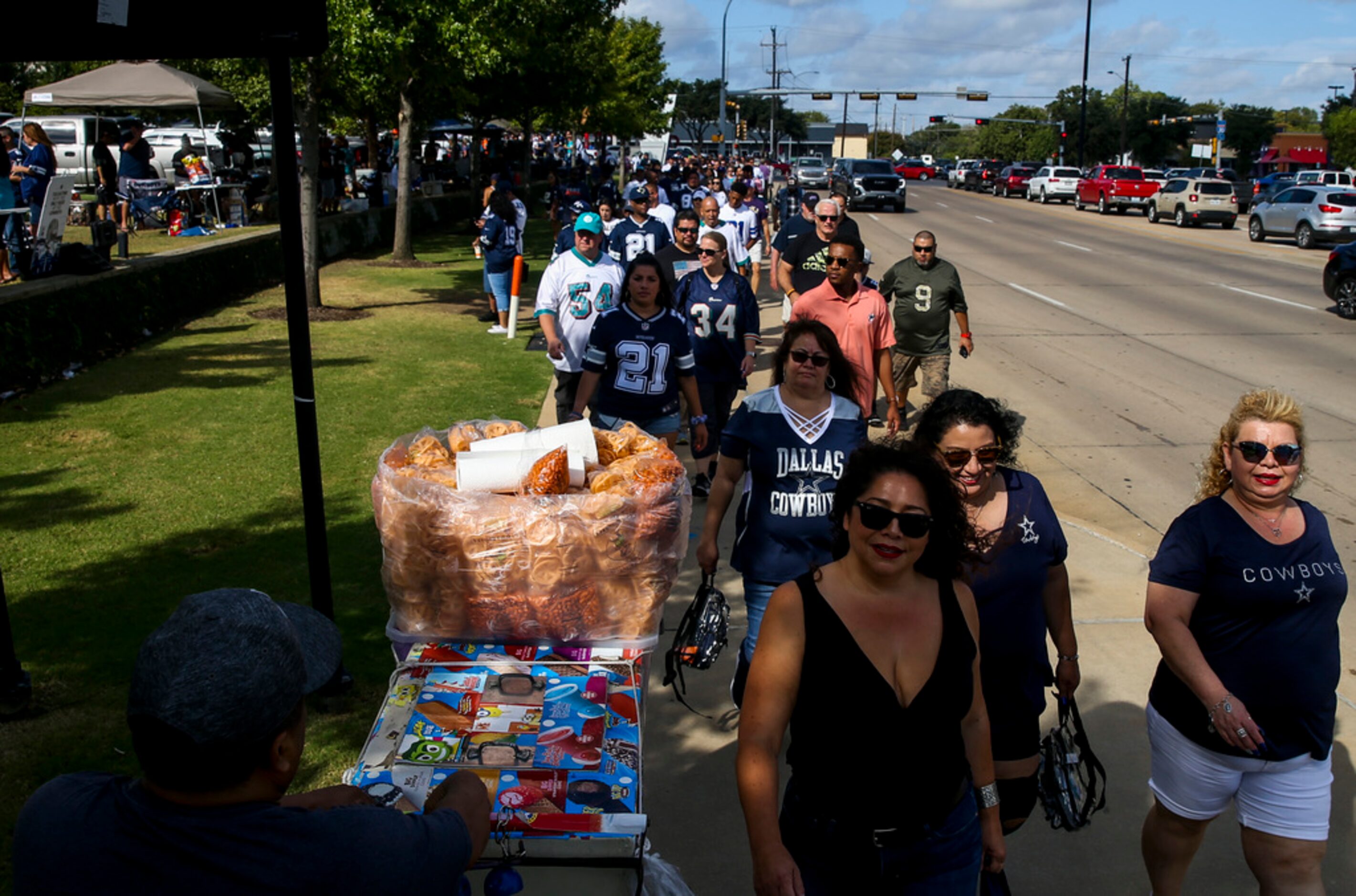 Fans make their way to the stadium before an NFL game between the Miami Dolphins and the...