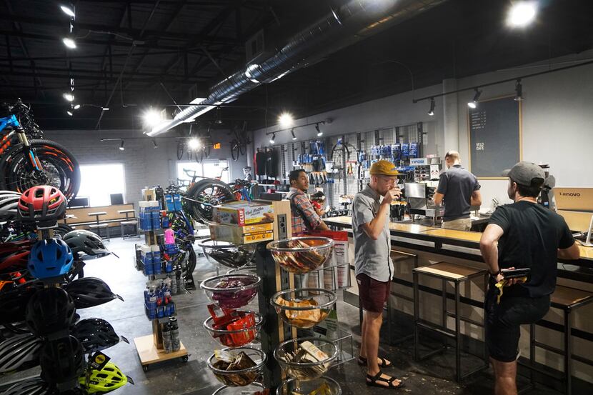 Customers hang out at the coffee bar at the new Velo Cafe in Keller. It's a bike shop that...