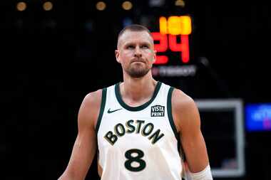 Boston Celtics center Kristaps Porzingis (8) walks up court during the first half of an NBA...