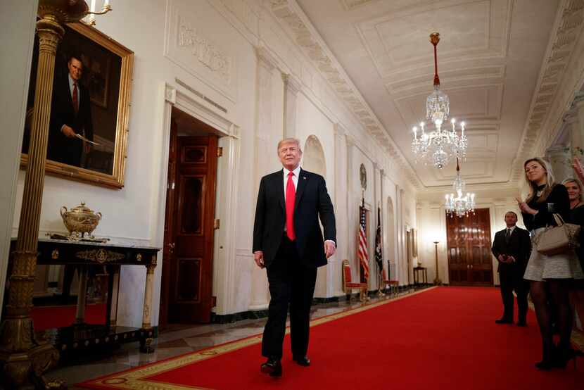 President Donald Trump walks through the White House.