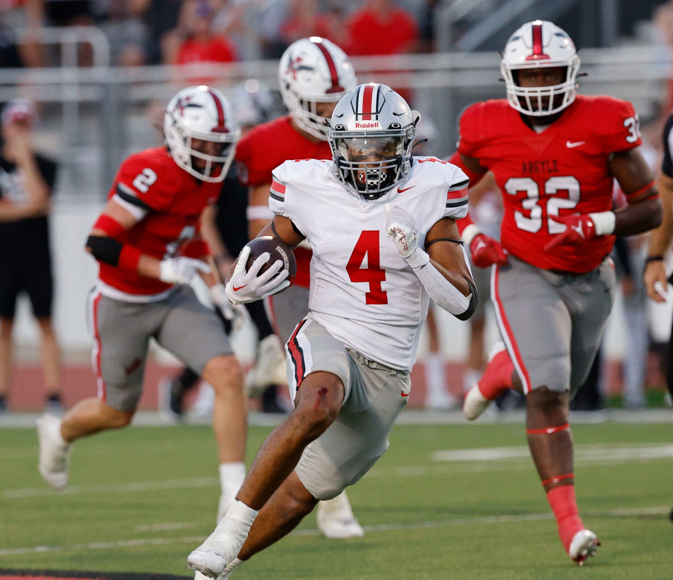 Lovejoy's Dante Dean (4) carries the ball as Argyle's Max Bland (32) and Argyle's Garrett...