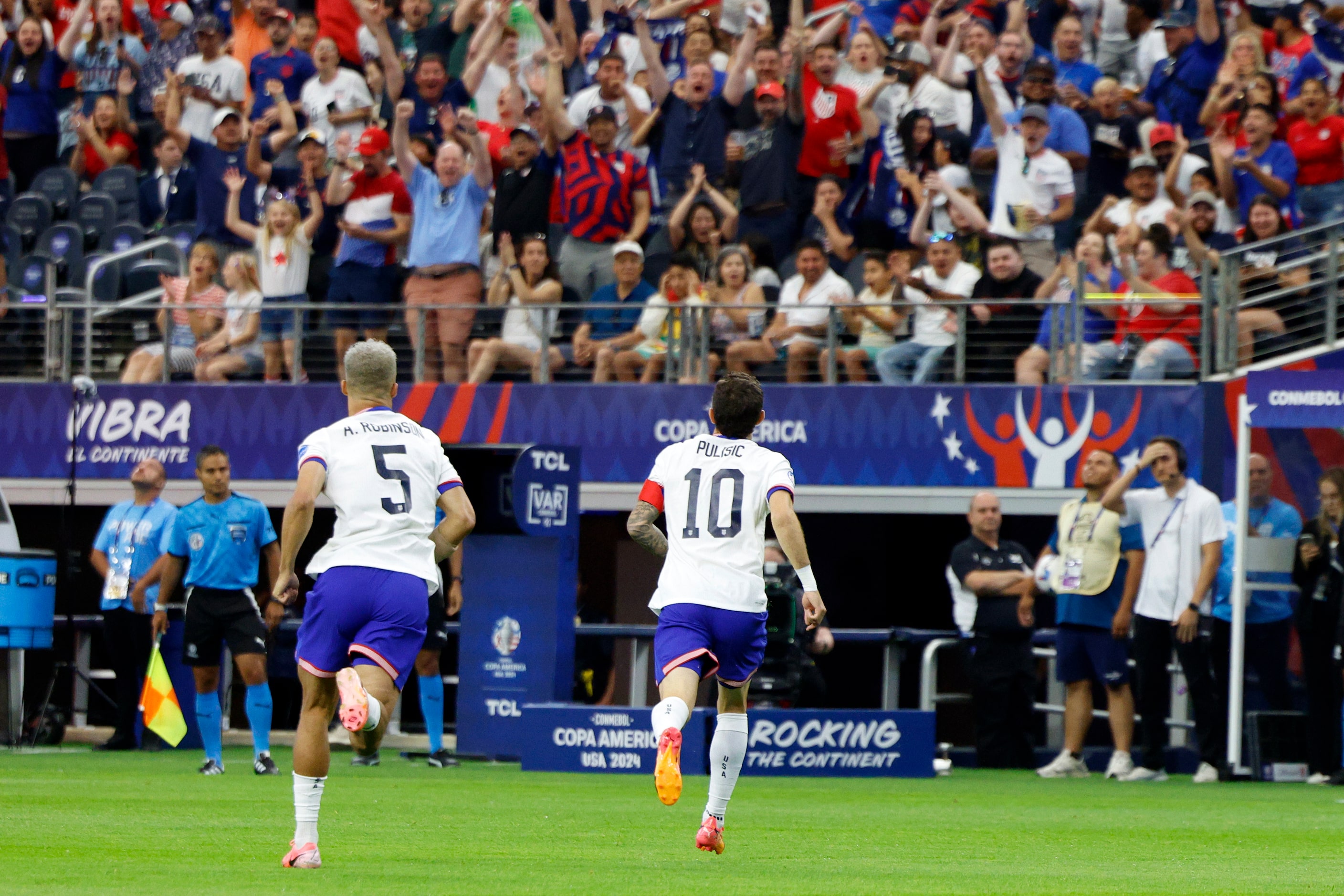 United States forward Christian Pulisic (10) celebrates with defender Antonee Robinson (5)...